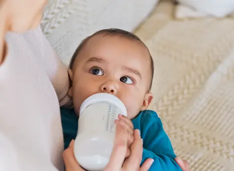 Parent bottle feeding baby, part of baby feeding tips for parents