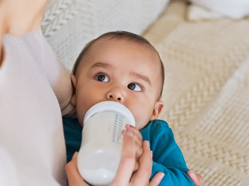 Parent bottle feeding baby, part of baby feeding tips for parents