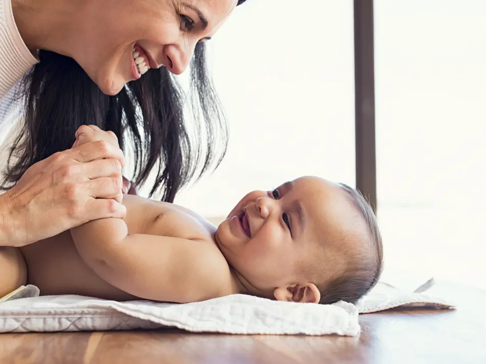 Mum playing with baby following daily routine