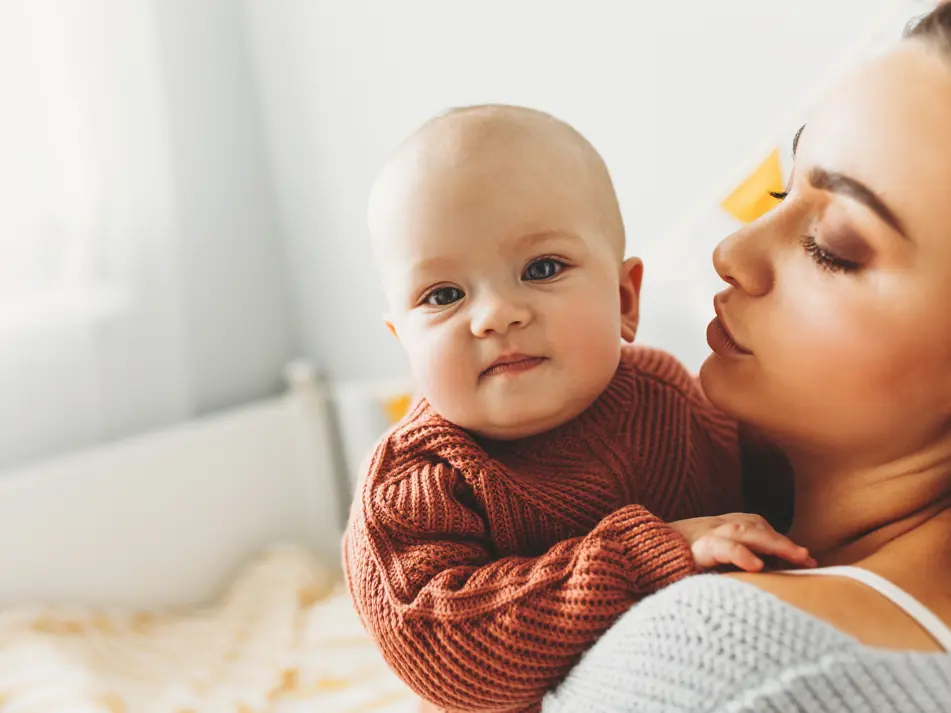 Mum caring for newborn, featured on page with newborn parenting tips and expert guidance