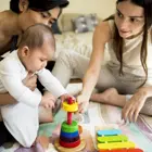 Parents working on baby milestones through play
