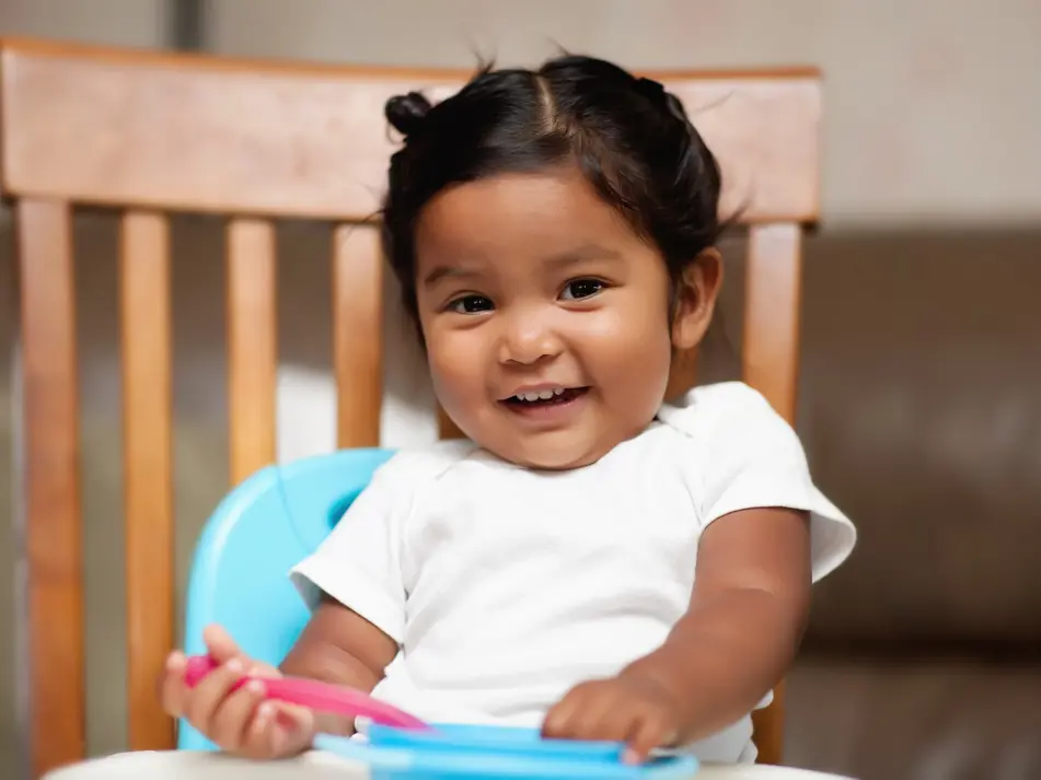 Happy toddler smiling, supporting toddler development tips and parenting advice